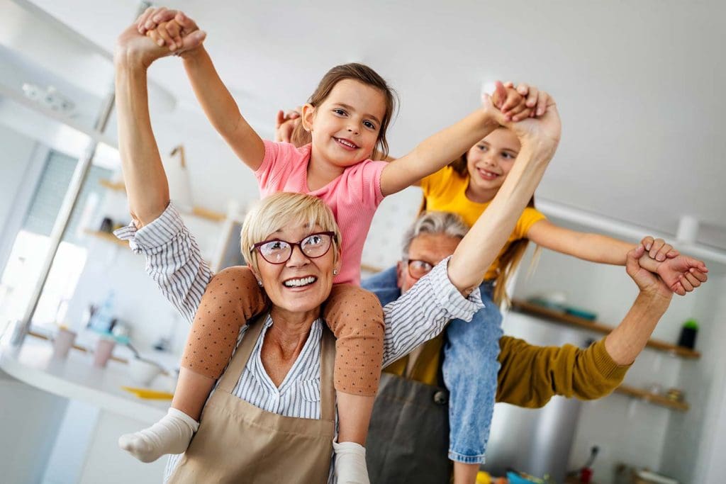 Portrait of happy elderly couple and grandchildren